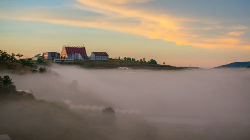 Scenic view of buildings against sky during sunset