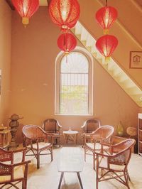 Empty chairs and table against building