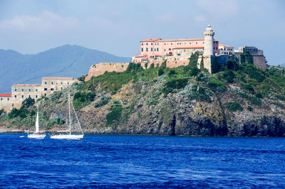 Scenic view of sea against buildings