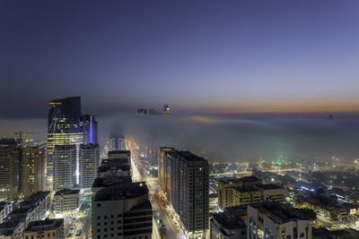 High angle view of illuminated buildings in city against sky