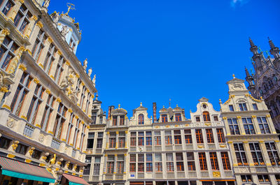 Low angle view of buildings against blue sky