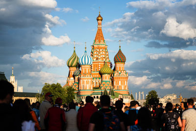 People standing in front of church against sky