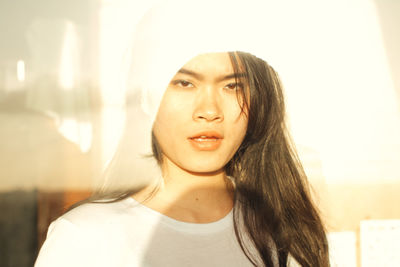 Close-up portrait of woman outdoors in sunny day