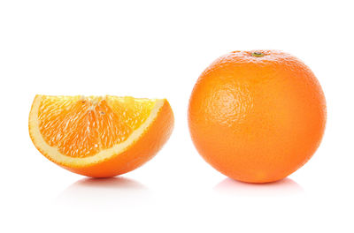 Close-up of orange fruit against white background