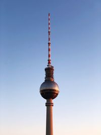 Low angle view of communications tower against sky