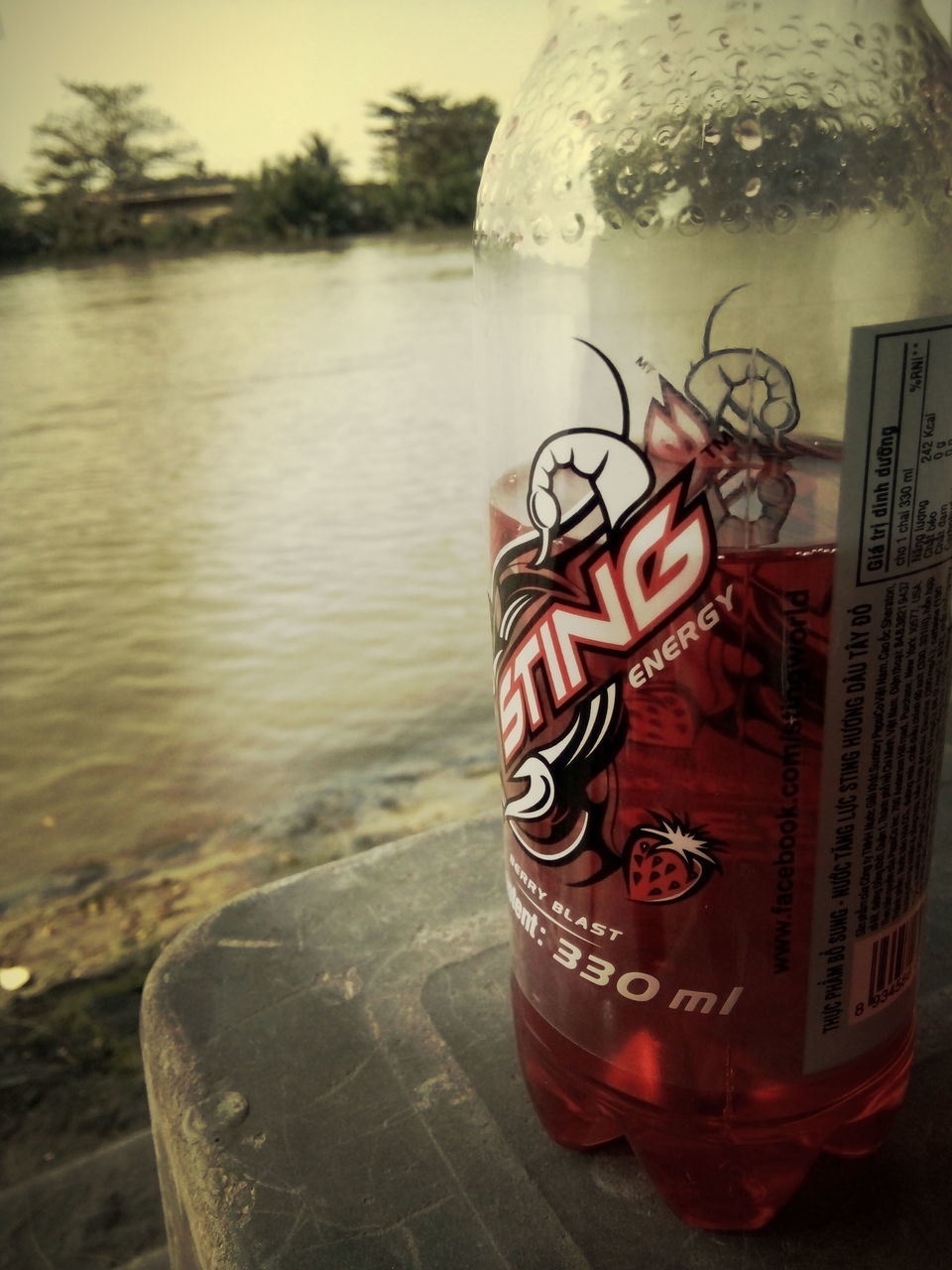 water, close-up, text, focus on foreground, red, reflection, western script, communication, no people, day, outdoors, lake, table, river, glass - material, drink, still life, sea, single object, transparent