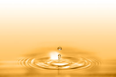 Close-up of drop falling in water