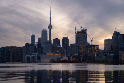 View of buildings in city against cloudy sky