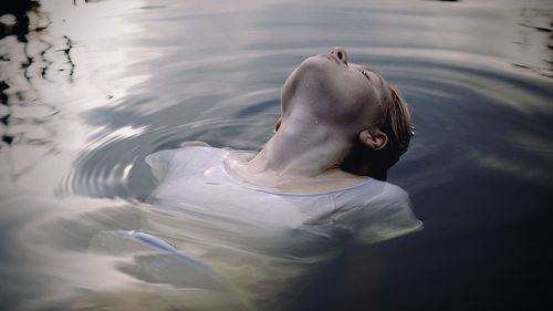 High angle view of man swimming in lake