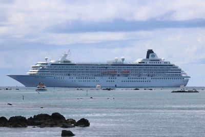 Ship sailing on sea against sky