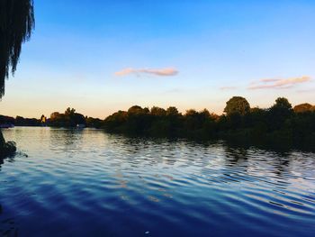 Scenic view of lake against sky at sunset