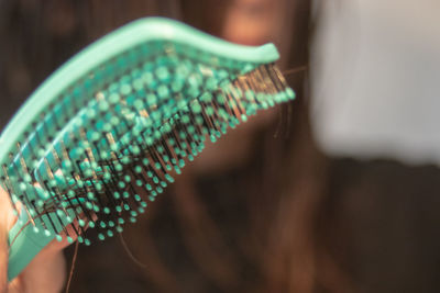 Close-up of hand holding light bulb