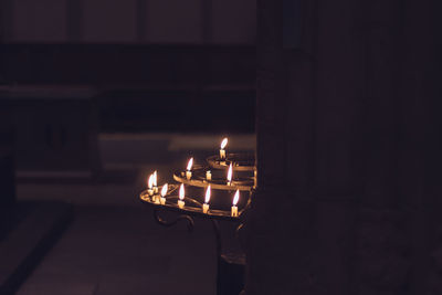 Close-up of burning candles in dark