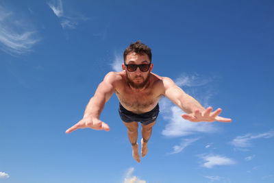 Portrait of young man against sky