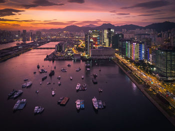 Aerial view of illuminated city by river at night