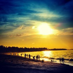 People on beach at sunset