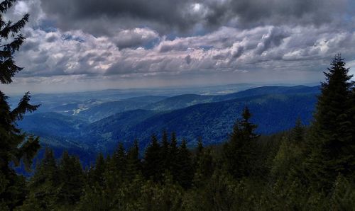 Scenic view of mountains against cloudy sky