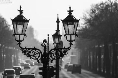 Close-up of street light against sky in city