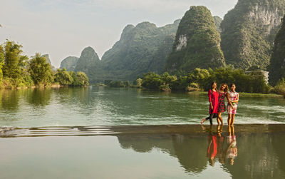 Three beautiful women standing in the river li close to yangshuo