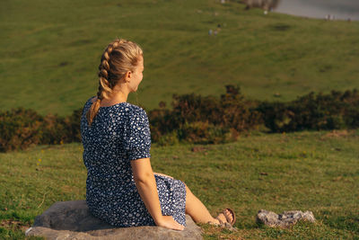 Woman sitting on field