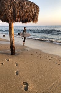 Full length of boy on beach against sky