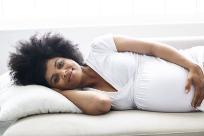 Portrait of pregnant woman relaxing on couch