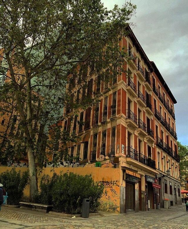 architecture, building exterior, built structure, sky, tree, residential building, residential structure, city, low angle view, building, window, street, facade, house, outdoors, day, cloud, incidental people, city life, no people