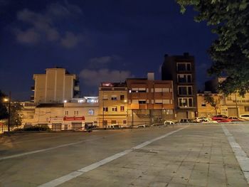 Street amidst buildings in city against sky