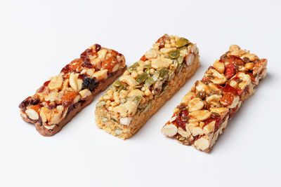 Three protein bars with cereals isolated on a white background close-up.