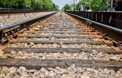 Diminishing perspective of railroad tracks during sunny day