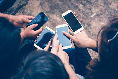 Midsection of man using mobile phone