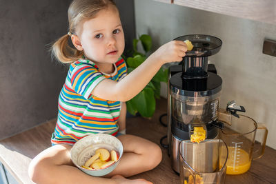 High angle view of cute girl holding coffee