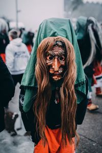 Person wearing mask on street during carnival