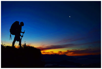 Silhouette person against sky at night