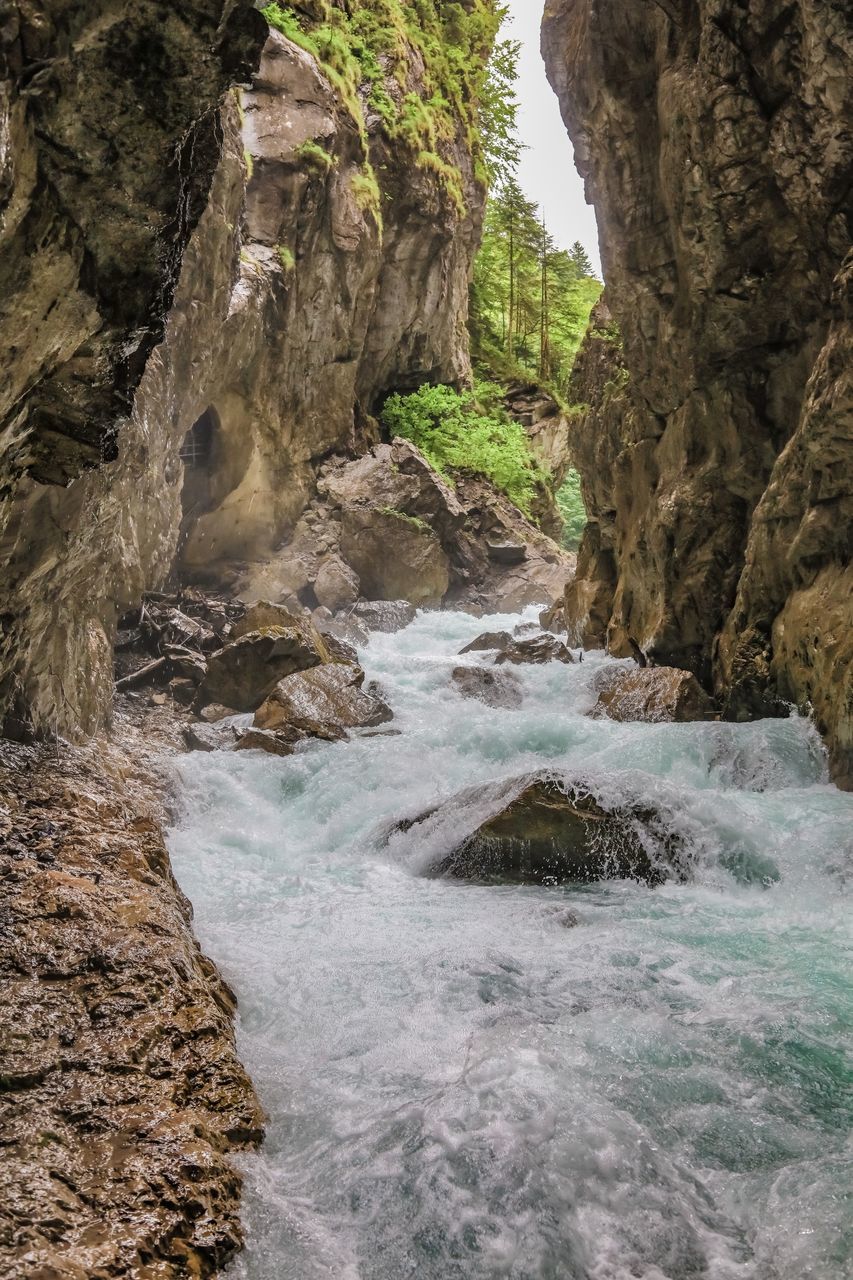 WATER FLOWING THROUGH ROCKS