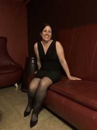 Portrait of a smiling young woman sitting at home