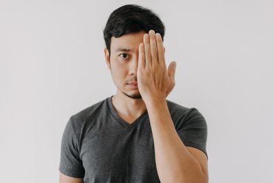 Portrait of young woman against white background