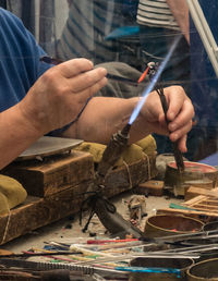 Midsection of man working at workshop