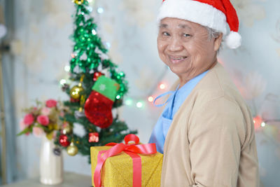 Portrait of teenage girl with christmas tree