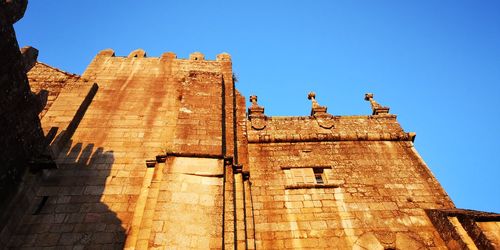 Low angle view of historical building against blue sky