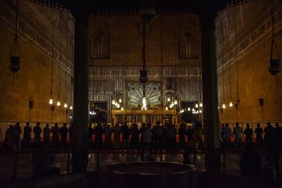 Group of people in illuminated building at night