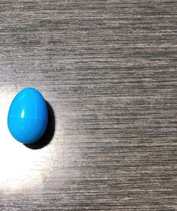 Directly above shot of blue balloon on table against wall