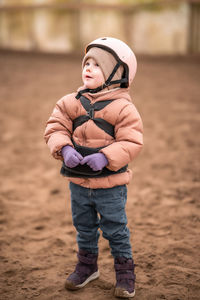 Full length of cute boy standing on field