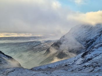 Scenic view of snow covered mountains against sky