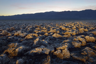 Scenic view of rocks against sky during sunset