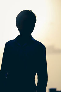 Rear view of silhouette man against clear sky