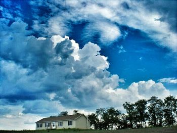 Low angle view of building against cloudy sky