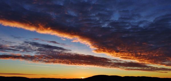 Scenic view of dramatic sky during sunset