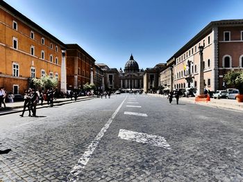 View of city street and buildings against sky