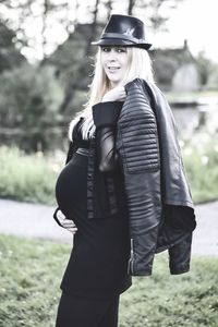 Portrait of smiling young woman standing outdoors